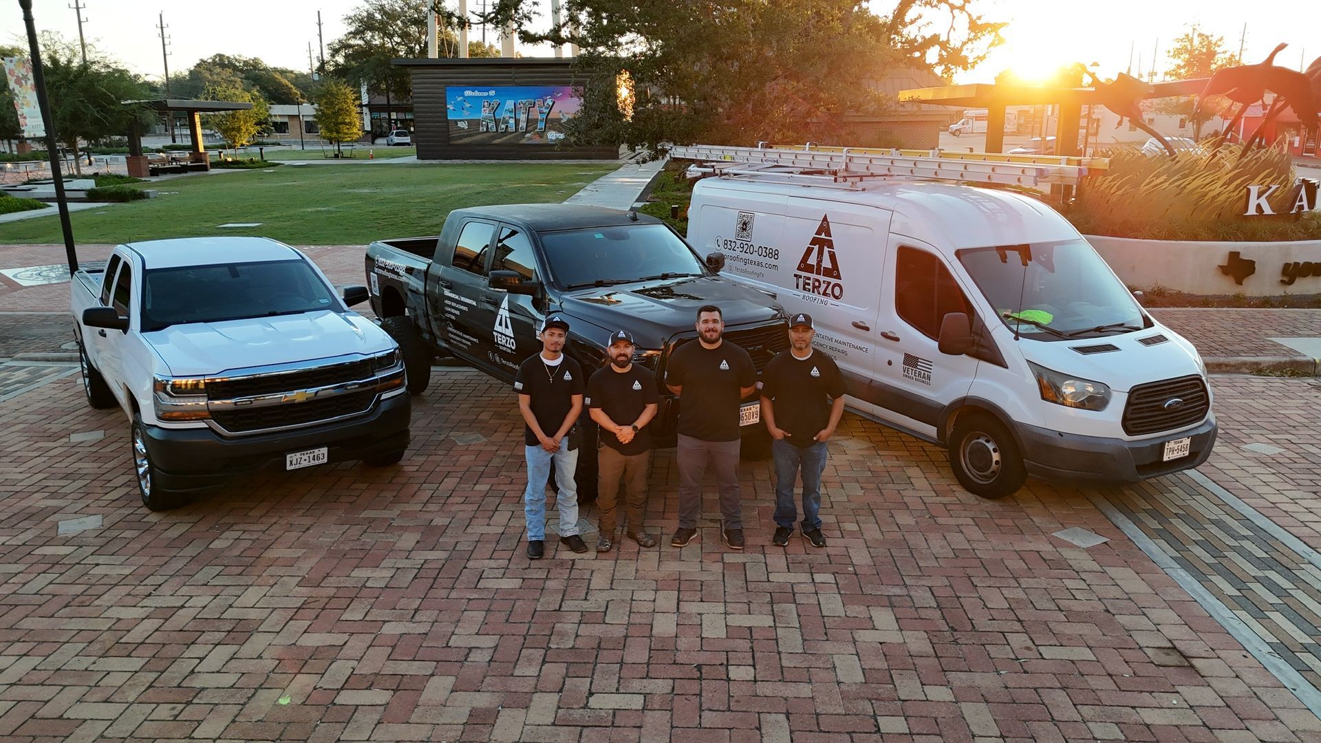 The Terzo Roofing team standing in front of company trucks in Houston, TX